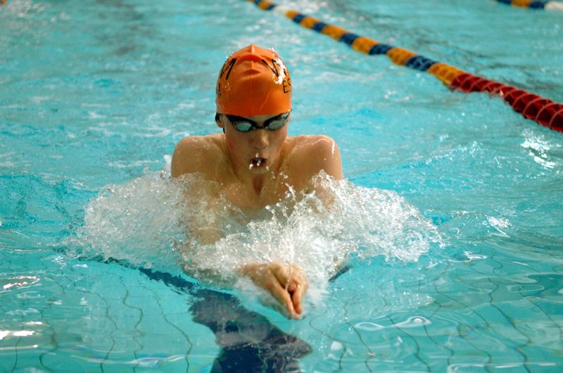 Young man swimming in swimming pool